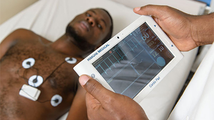 A health practitioner uses the Cardio Pad to transmit cardiac test results to specialists.