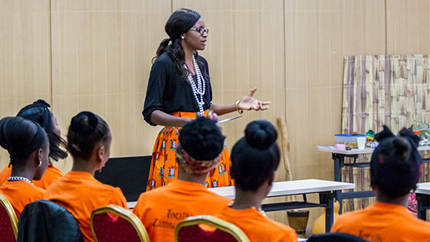 Young woman teaching a class of younger girls.