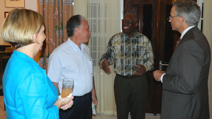Surinamese Alumni gather with Ambassador Anania, right, and former President Venetiaan, gesturing in middle