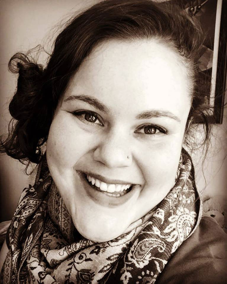 Black and white headshot photo of young lady smiling