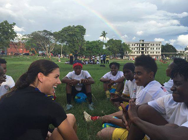 Sports Envoy Alex Morgan talking with youth soccer players in Tanzania.