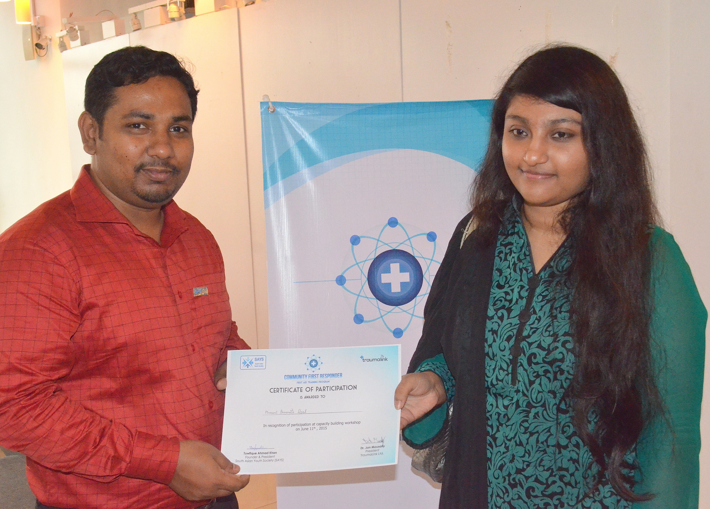 Young man holding and passing certificate to young lady