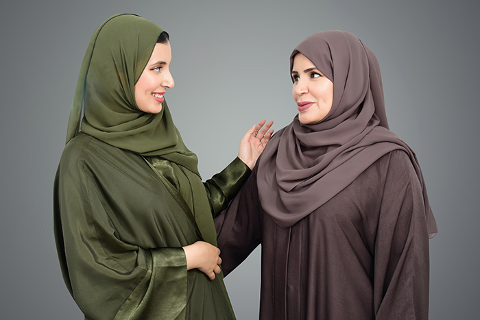 two women shaking hands