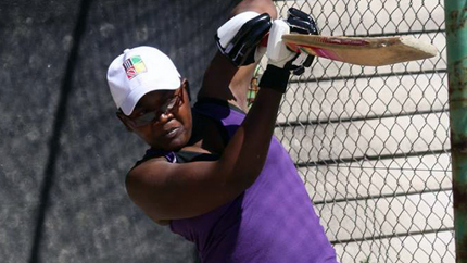 Grace hitting a drive down the off-side during a cricket training.