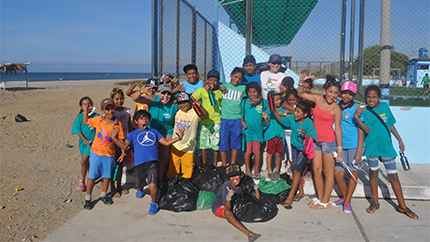 The "Sowing Awareness" AEIF project group teams up with kids to clean up trash on the local beach.