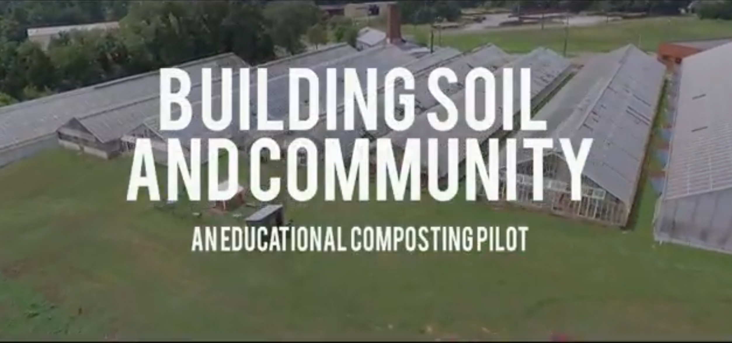 Aerial shot of greenhouses with title graphic overlay