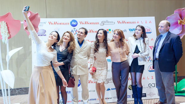Group of women and a man pose for a selfie