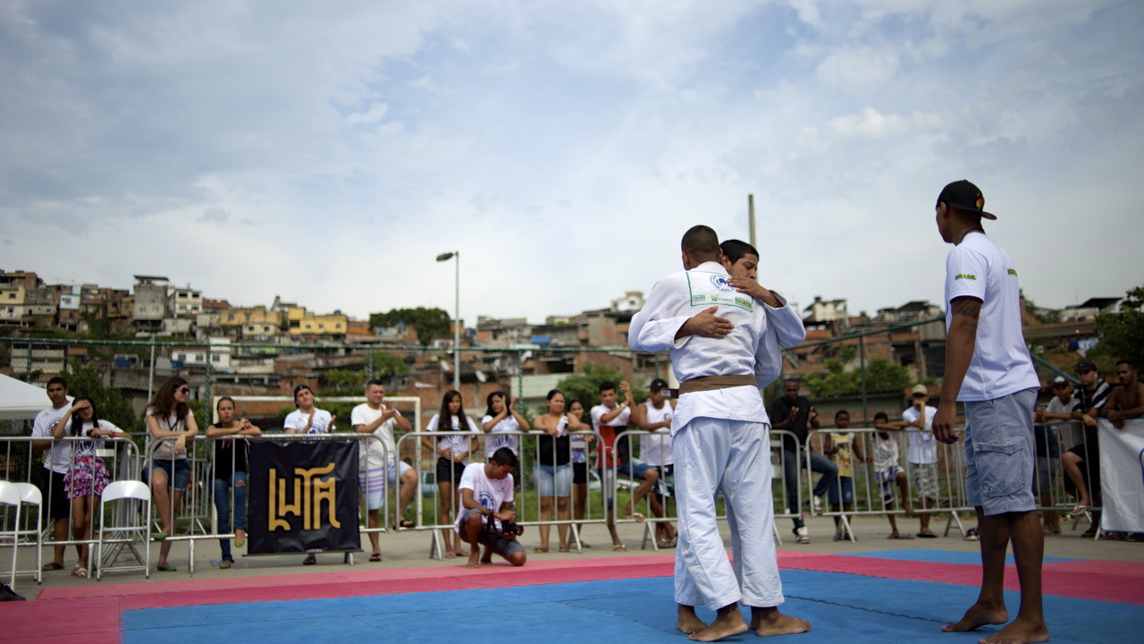 Two Jiu-Jitsu practitioners embrace