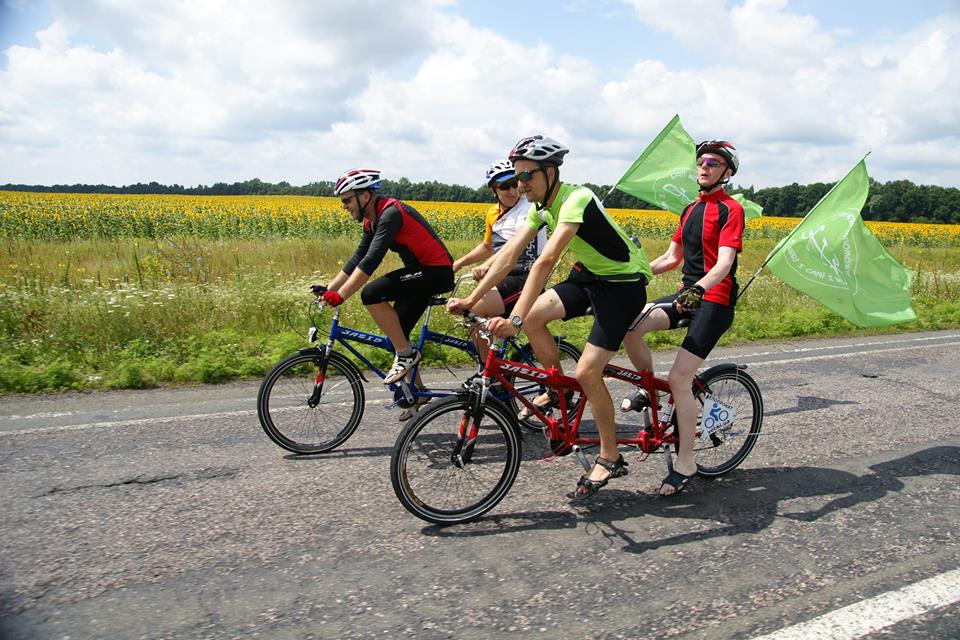 Four people riding on bikes in the sun