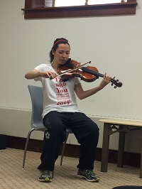 Amy Tran playing a violin 