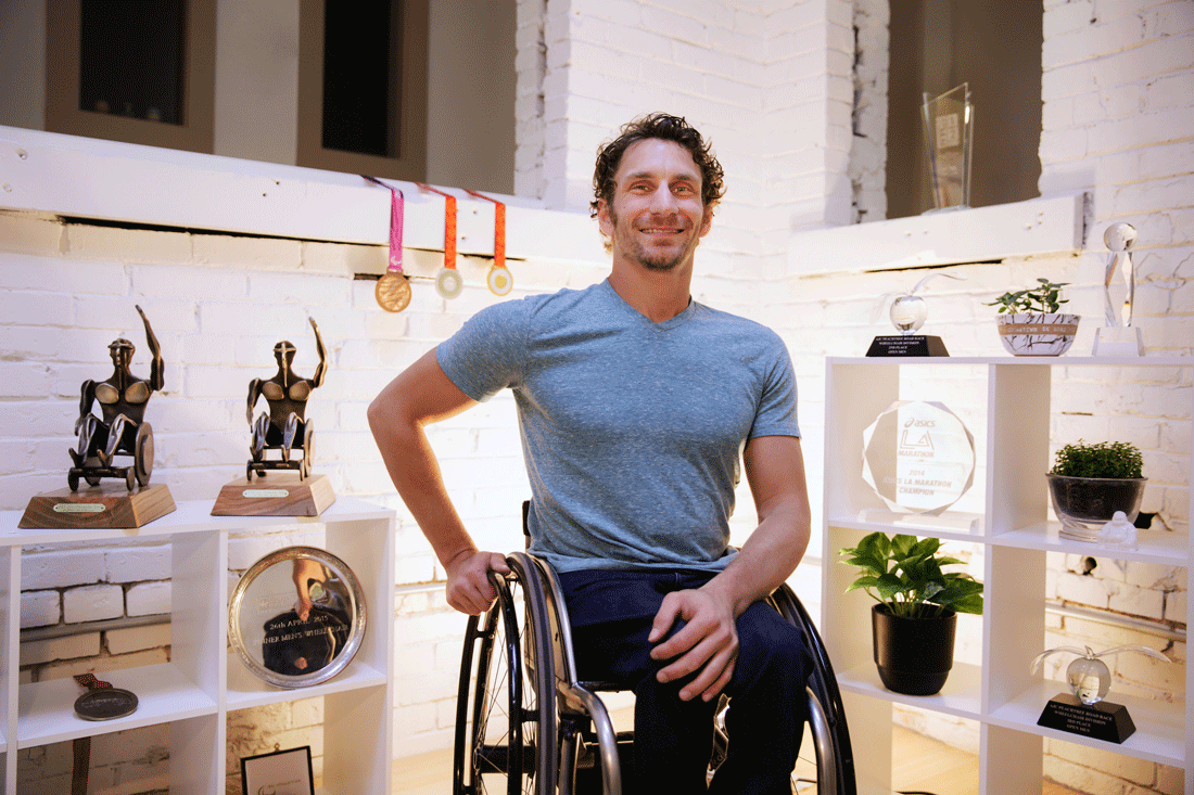Six-time world champion Paralympic racer Josh George poses with his championship awards and medals