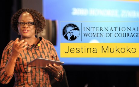 African woman holding a tablet while delivering a lecture