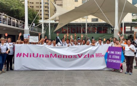 Women holding a large banner that reads "#NiUnaMenosVzla" marching against gender-based violence