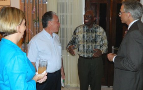 Surinamese Alumni gather with Ambassador Anania, right, and former President Venetiaan, gesturing in middle