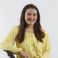 Smiling brown-haired girl with yellow shirt 