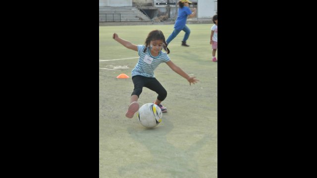 A young player practices her ball handling skills during a GO GIRL clinic